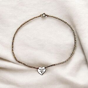 White heart emblem on a stainless steel necklace